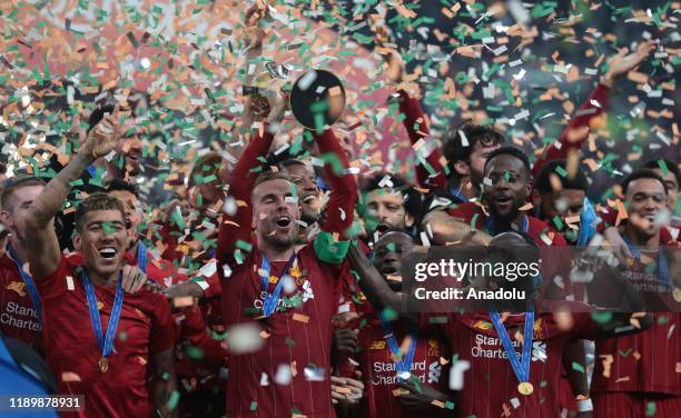 Players of Liverpool lift the trophy during a ceremony at the end of the FIFA Club World Cup Qatar 2019 Final match between Liverpool FC and CR...