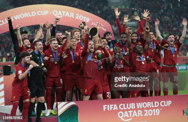 Players of Liverpool lift the trophy during a ceremony at the end of the FIFA Club World Cup Qatar 2019 Final match between Liverpool FC and CR...