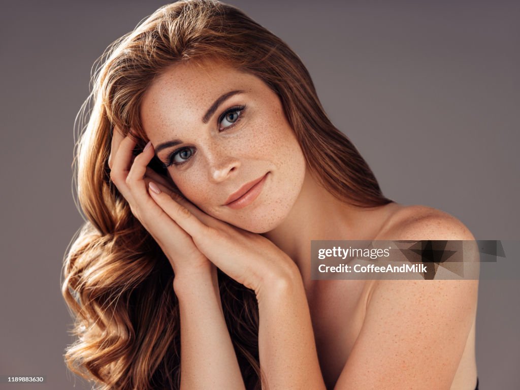 Young beautiful model with long wavy well groomed hair
