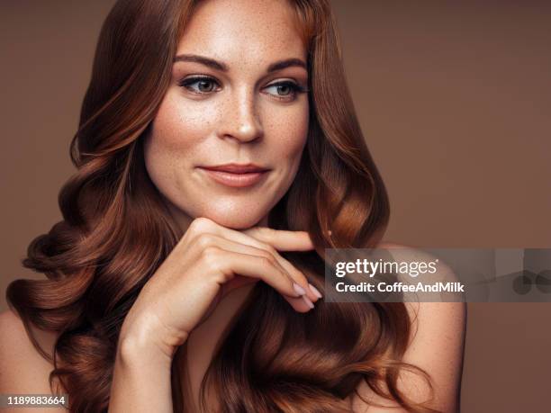 young beautiful model with long wavy well groomed hair - woman long brown hair stock pictures, royalty-free photos & images