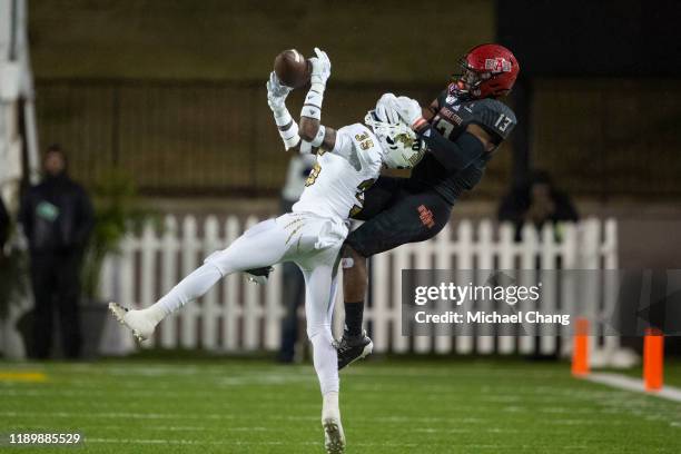 Defensive back Rishard Dames of the FIU Golden Panthers intercepts the ball intended for wide receiver Kirk Merritt of the Arkansas State Red Wolves...