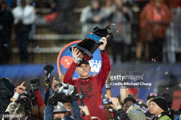 Head coach Blake Anderson of the Arkansas State Red Wolves holds up the Camellia Bowl trophy after defeating the FIU Golden Panthers in the Camellia...