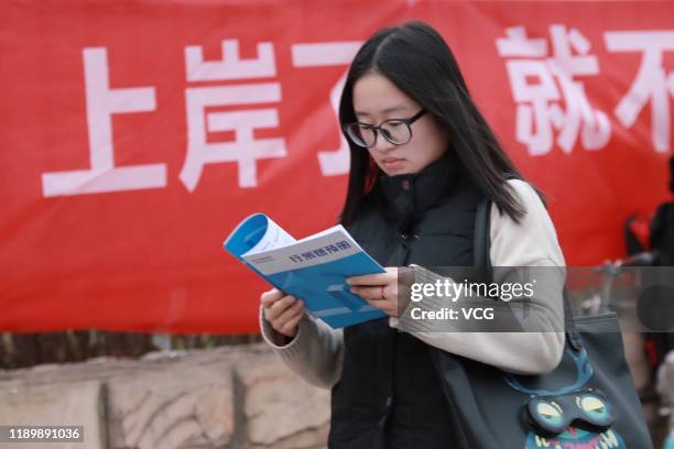 An examinee reviews materials at an exam site of the national civil servant exam on November 24, 2019 in Taiyuan, Shanxi Province of China. About 965...