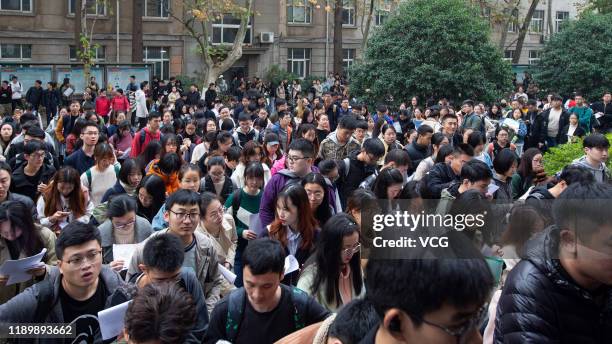 Examinees walk in an exam site of the national civil servant exam on November 24, 2019 in Nanjing, Jiangsu Province of China. About 965 thousand...