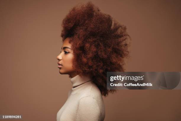 photo of cheerful curly girl with positive emotions - girl in winter coat studio stock pictures, royalty-free photos & images