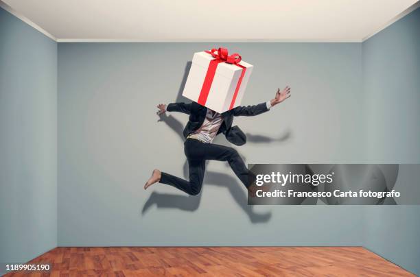 businessman with a large gift package - breaking out of the box stock pictures, royalty-free photos & images