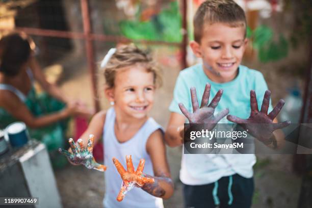 cheerful little children with colorful paint on hands - 4 girls finger painting stock pictures, royalty-free photos & images