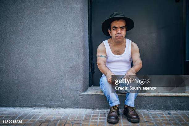 cute little man sitting on the sidewalk - dwarf stock pictures, royalty-free photos & images