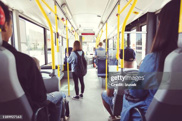 males and females commuting by public transport - bus uk stock pictures, royalty-free photos & images