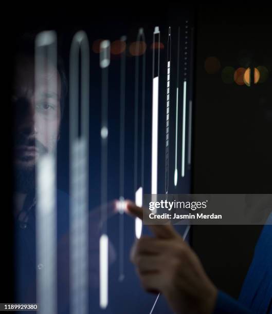 man operating in control room moving sliders on screen - interactive whiteboard foto e immagini stock