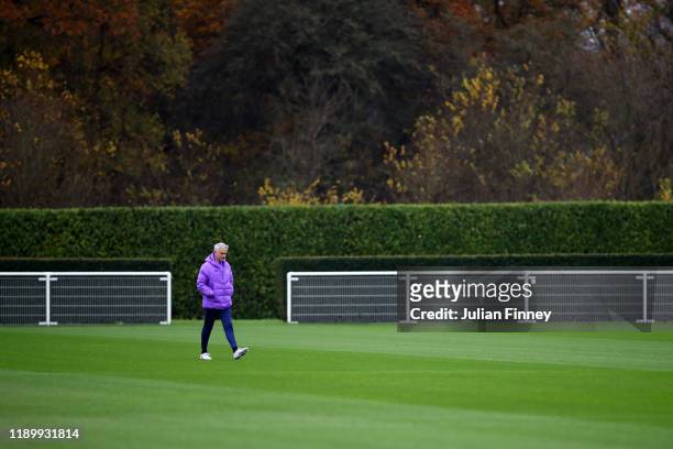 Jose Mourinho, Manager of Tottenham Hotspur walks across the pitch during a training session ahead of their UEFA Champions League group B match...