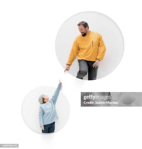 conceptual father son touch on wall circle - dad advice stock pictures, royalty-free photos & images