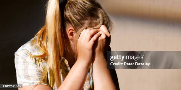 depressed teenager, head in hands - victim stock pictures, royalty-free photos & images