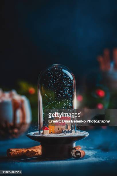 christmas miniature town under snow in a glass dome. creative still life with copy space - empty snow globe stock-fotos und bilder
