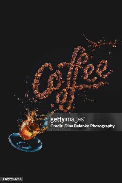 coffee lettering made out of coffee beans with a flying espresso cup and coffee splash. action food photography - coffee slow motion stock pictures, royalty-free photos & images