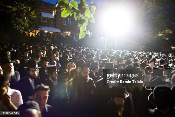 Thousands of Hasidic men wait for a procession for the body of Leibby Kletzky, a murdered eight-year-old boy who went missing from the Hasidic...