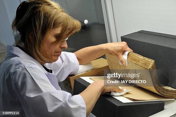 By Cecil Morella In this photo taken May 4 German restorer Monika Schneider-Gast works on restoring the hand-written novels, the original editions of...