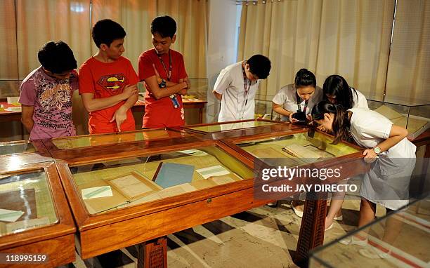 By Cecil Morella In this photo taken June 17 students view the restored hand-written novels, the original editions of national hero Jose Rizal's...