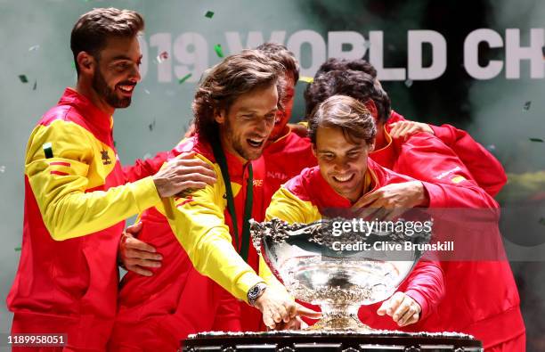 Marcel Granollers, Feliciano Lopez, Pablo Carreno Busta, Roberto Bautista Agut and Rafael Nadal celebrate with the trophy following their victory...