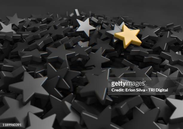 mountain of gray stars and one golden one highlighted at the top. - celebrities on the set of univisions despierta america stockfoto's en -beelden