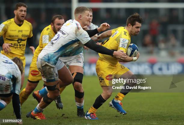 Arthur Retiere of La Rochelle is tackled by Rob du Preez during the Heineken Champions Cup Round 2 match between Sale Sharks and La Rochelle at AJ...