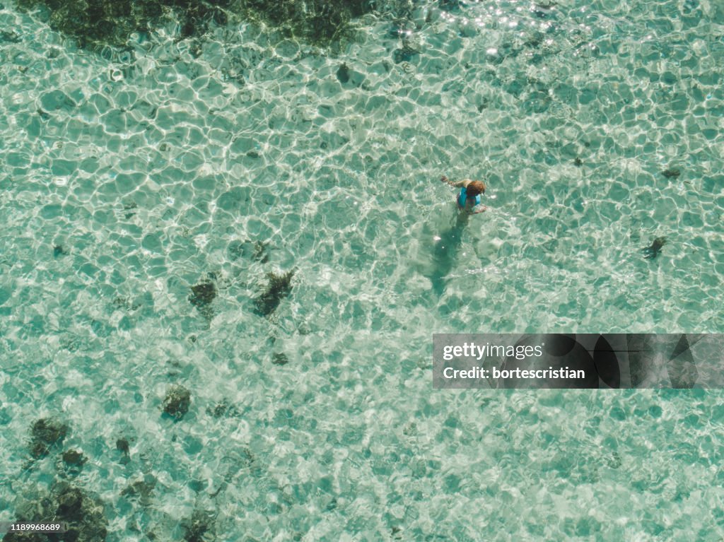 High Angle View Of Woman Standing In Sea