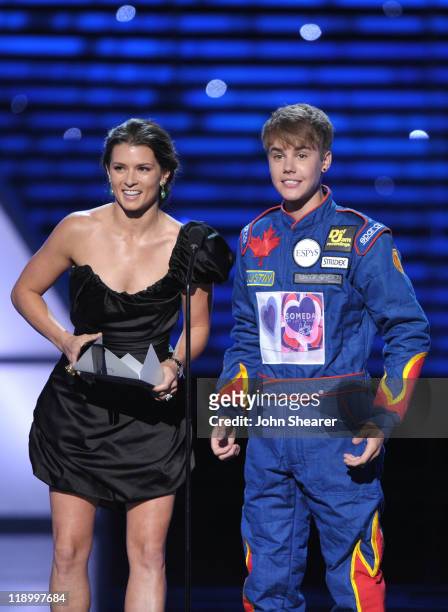 Race car driver Danica Patrick and singer Justin Bieber present the award for 'Best Team' onstage at The 2011 ESPY Awards held at the Nokia Theatre...