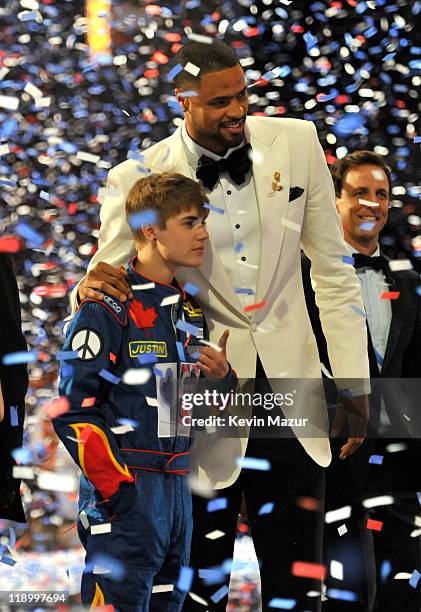 Singer Justin Bieber and Tyson Chandler of the Dallas Mavericks onstage after the Mavericks won the ESPY for 'Best Team' at The 2011 ESPY Awards held...