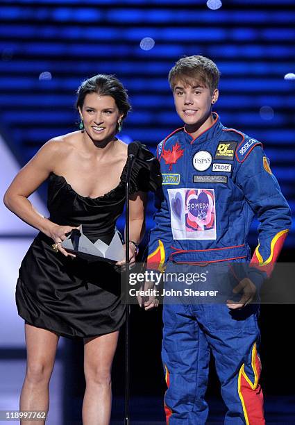 Race car driver Danica Patrick and singer Justin Bieber present the award for 'Best Team' onstage at The 2011 ESPY Awards held at the Nokia Theatre...