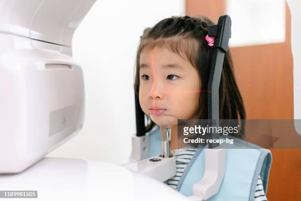 girl at dentist x-ray machine - skull xray no brain stock pictures, royalty-free photos & images