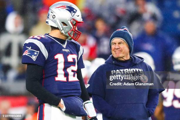 Tom Brady talks to head coach Bill Belichick of the New England Patriots before a game against the Dallas Cowboys at Gillette Stadium on November 24,...