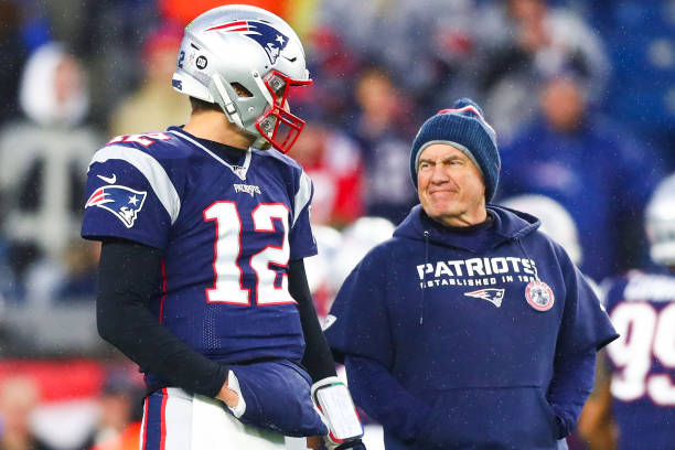 Tom Brady talks to head coach Bill Belichick of the New England Patriots before a game against the Dallas Cowboys at Gillette Stadium on November 24,...