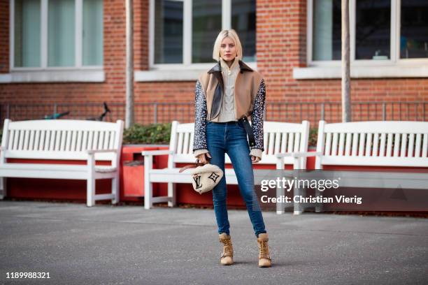 Lisa Hahnbück is seen wearing Louis Vuitton FW19 jacket, Cult Gaia knit with zipper, dark blue denim skinny jeans JBrand, Chloe Riley boots, Louis...