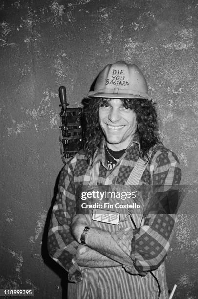 English musician Michael Burston , aka Wurzel, the guitarist from heavy metal band Motorhead, in London, July 1984. He is wearing a hard hat on which...