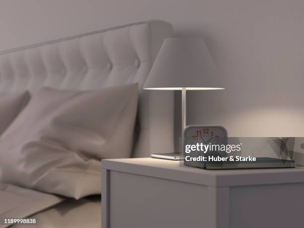 alarm clock on bedside table - night table stock pictures, royalty-free photos & images