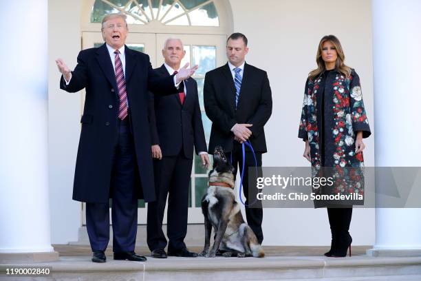 President Donald Trump, Vice President Mike Pence, an unidentified dog handler and first lady Melania Trump pose for photographs with Conan, the U.S....