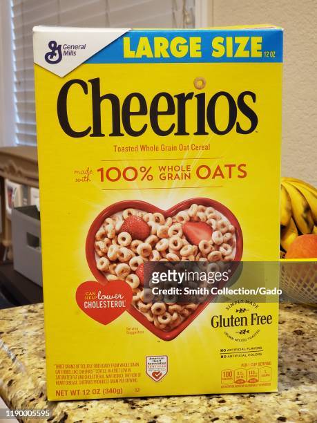 Close-up of box of Cheerios breakfast cereal on a countertop in a domestic kitchen, from parent company General Mills, August 20, 2019.
