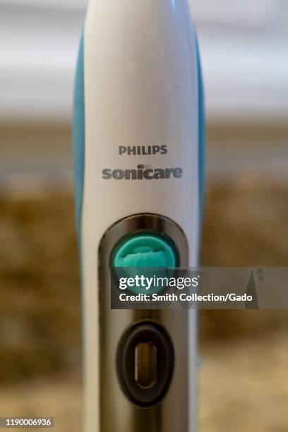 Close-up of logo on handle of Philips Sonicare electronic tooth brush in domestic bathroom, August 21, 2019.