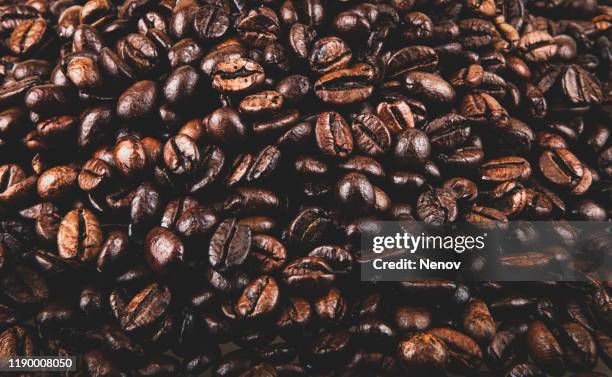 close-up of coffee beans background - rohe kaffeebohne stock-fotos und bilder