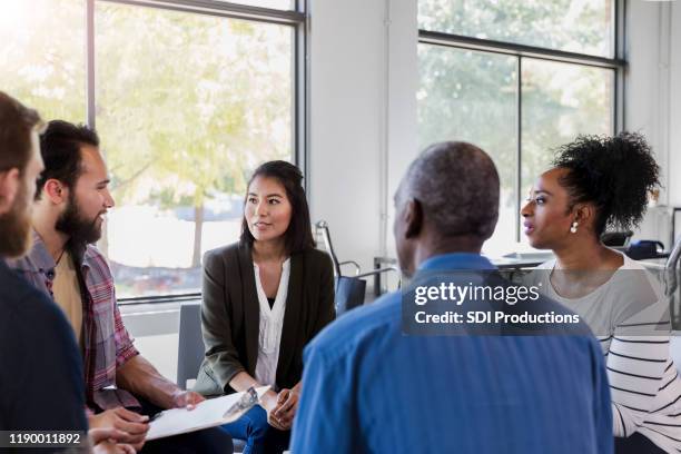 mid adult business professionals hold monthly meeting - focus group discussion stock pictures, royalty-free photos & images