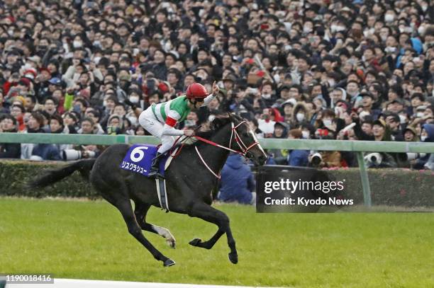 Australian jockey Damian Lane reacts after steering Lys Gracieux to the Grade 1 title at the 64th Arima Kinen at Nakayama Racecourse near Tokyo on...