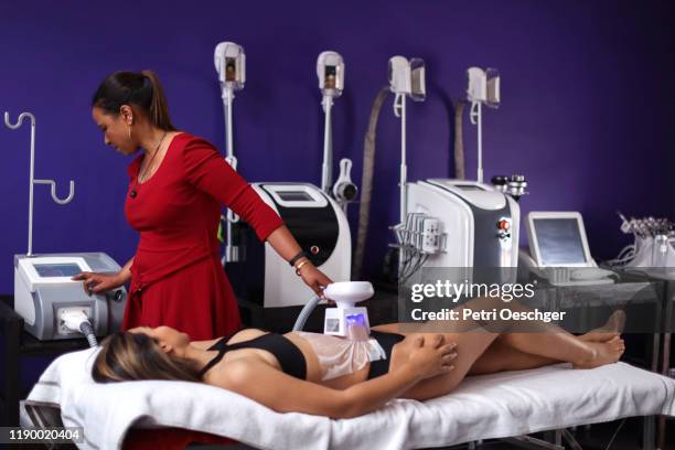 a young woman receiving a new age beauty treatment - suction tube stock pictures, royalty-free photos & images