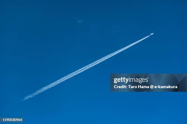 the airplane flying in the blue sky in japan - vapour trail stock pictures, royalty-free photos & images