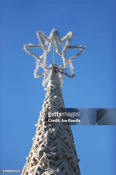 The star is seen atop of “Sandi,” the world’s only 700-ton sand tree as sculptors from Sandtastic near the completion of the holiday sand tree on...