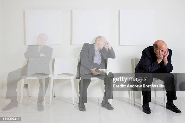 bored senior man passing time in a waiting room - impatient stock pictures, royalty-free photos & images