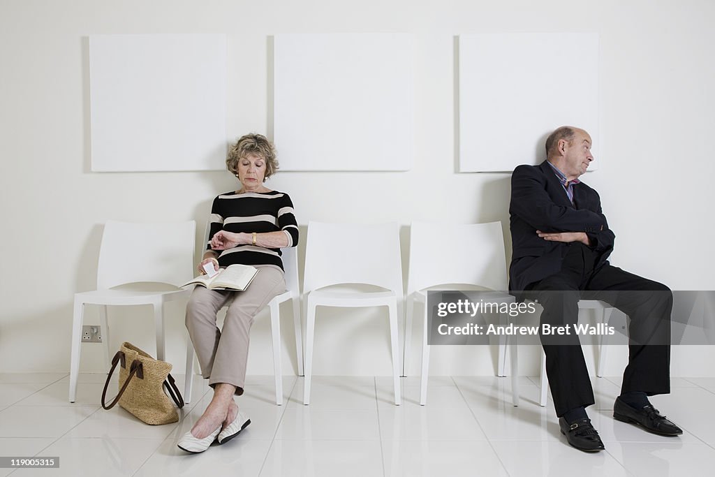 Bored senior man & woman in a waiting room