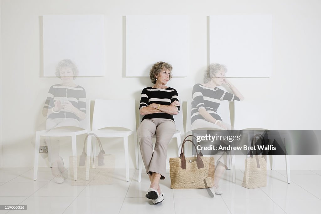 Bored senior woman passing time in a waiting room