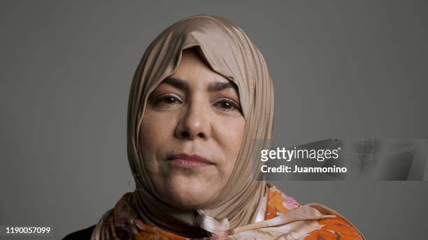 mature muslim woman looking at the camera - chubby arab stock pictures, royalty-free photos & images