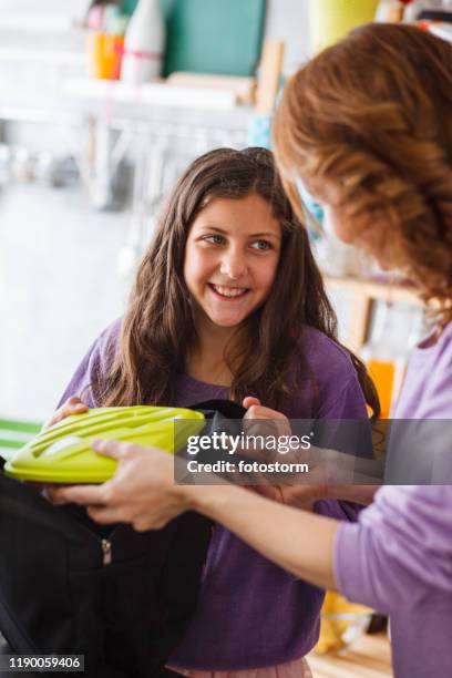 girl packing lunch box into school backpack - packing food stock pictures, royalty-free photos & images