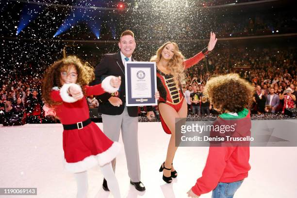 Mariah Carey is awarded a Guinness World Record by official Guinness adjudicator Michael Empric for “Highest-charting holiday song on the US Hot 100...